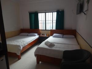 Postel nebo postele na pokoji v ubytování Thuong Hai Hotel