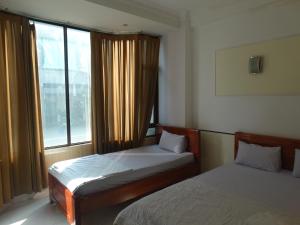 Postel nebo postele na pokoji v ubytování Thuong Hai Hotel