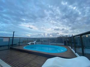 a swimming pool on the roof of a building at Tambaú Beach apartment in João Pessoa
