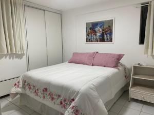 a bedroom with a bed and a picture on the wall at Tambaú Beach apartment in João Pessoa +33 photos
