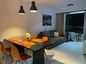 a living room with a table and a couch at Tambaú Beach apartment in João Pessoa