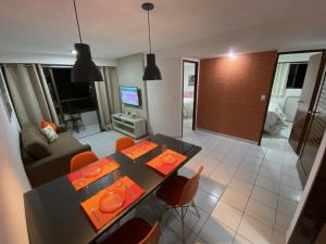 a kitchen and living room with a dining table and chairs at Tambaú Beach apartment in João Pessoa