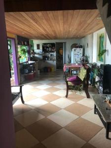 a living room with a tile floor and a table at PACHAMAMA in Rio de Janeiro