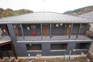 a large building with a balcony and a deck at ヒルトップ箱根入生田202 in Odawara