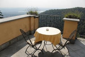 a table and two chairs on a balcony at Hotel Colonne in Varese