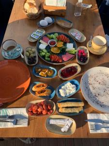 a wooden table with plates of food on it at Antalya Inn Hotel in Antalya