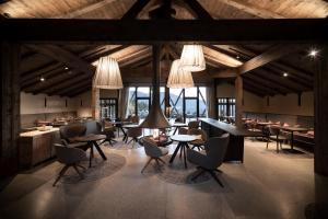 a restaurant with tables and chairs in a building at Gfell in Vols am Schlern