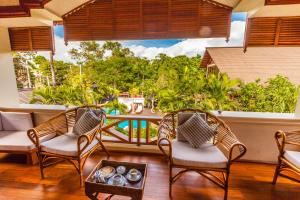 a patio with chairs and a table and a pool at The Hotel by the Red Canal in Mandalay