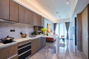 a kitchen with wooden cabinets and a counter top at Kezan Condo Hotel in Shenzhen