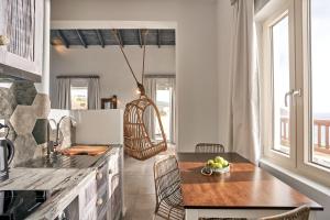 a kitchen with a table with a bowl of fruit on it at Althea Boutique Hotel in Amoopi