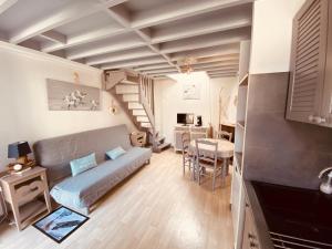a living room with a couch and a table at La Cabourgeaise in Cabourg