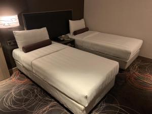 Postel nebo postele na pokoji v ubytování City Suites - Kaohsiung Chenai