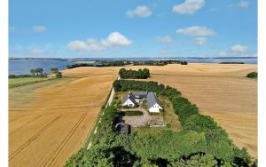 an aerial view of a house in the middle of a field at Rolsø Retreat - the apartment in Knebel