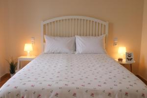 a bedroom with a large white bed with two lamps at ☆Minimal 6 floor Apartment in the Center of Patras in Patra