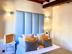 a bed with a blue headboard in a room at Palace Fontana di trevi Apartments in Rome