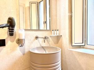 a bathroom with a sink with a faucet at Palace Fontana di trevi Apartments in Rome +19 photos