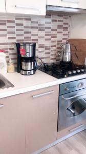 a kitchen with two pots and a stove top oven at DİHA RECIDENS in Istanbul