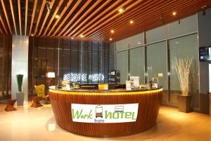 a lobby with a counter with a work motel sign on it at The Signature Hotel & Serviced Suites Kuala Lumpur in Kuala Lumpur