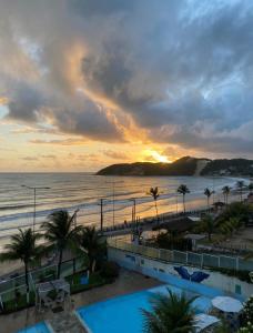 a view of the beach and the ocean at sunset at PONTA NEGRA BEACH - Natal in Natal