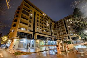 a building at night with a person standing in front of it at Apartments Athos in Podgorica
