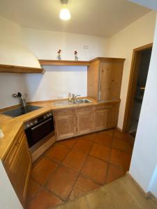 a kitchen with wooden cabinets and a sink at Ferienwohnung Christensen in Murnau am Staffelsee
