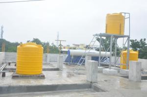 a group of yellow cylinders sitting on top of a building at Hotel Aishwariyam in Tirukkadaiyūr