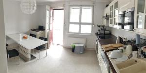 a kitchen with a sink and a table in it at Ferienhaus Elstal in Wustermark