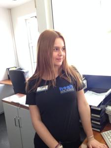 a woman standing in front of a desk in an office at hogh Hotel Heilbronn in Heilbronn