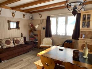 a living room with a couch and a table at Appenzellerland - Ferienhaus "Bömmeli" in Hundwil