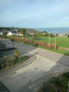 an empty road with the ocean in the background at Green Apple Bed and Breakfast in Carbis Bay
