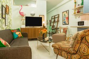 a living room with a couch and a tv at Flamingo Rosa in Arinaga