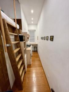 a hallway with a staircase and a room with boxes at Vila Mudroň - Studio in Vysoke Tatry - Dolny Smokovec