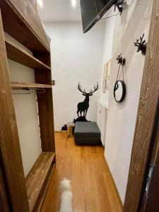 a hallway with a statue of a deer on the wall at Vila Mudroň - Studio in Dolný Smokovec