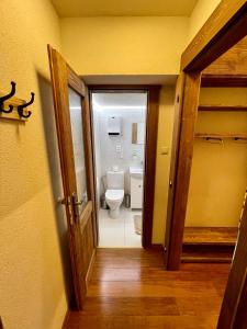 an open door to a bathroom with a toilet at Vila Mudroň - Studio in Vysoke Tatry - Dolny Smokovec