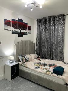a bedroom with a large bed and a window at 3 Bedroom Whalley Aparthotel in Burnley