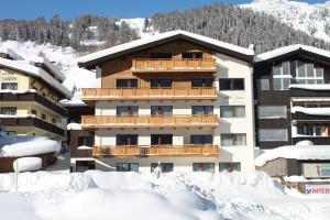 a hotel in the snow with snow covered buildings at Haus Roman Falch in Sankt Anton am Arlberg