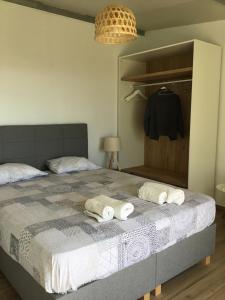 a bedroom with a bed with towels on it at Blue Sky in Frangokastello
