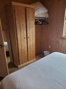 a bedroom with a bed and a cupboard at Chalets de l'Anse Ste Helene in Maria