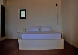 A bed or beds in a room at Pambelos Lodge