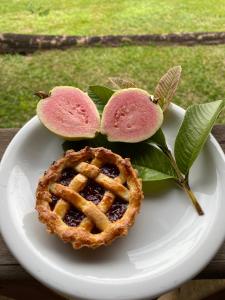 a white plate with a pie and a waffle at Sítio Tamanduá in Brotas