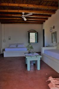 A bed or beds in a room at Pambelos Lodge