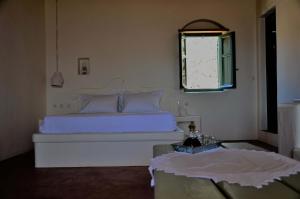 A bed or beds in a room at Pambelos Lodge