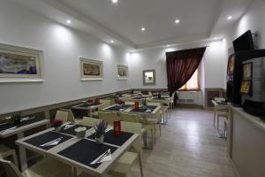 a restaurant with tables and chairs in a room at Hotel Concorde in Rome