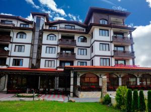 a large white building with balconies on it at Hotel Alegra in Velingrad