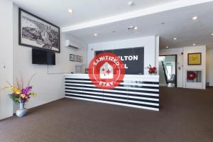 a waiting room with a sign on the wall at Super OYO 442 Marvelton Hotel in Butterworth