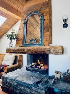 a fireplace in a living room with a mirror at Charming chalet 100m2, Heart of the 3 vallées, Meribel, Les Allues in Les Allues