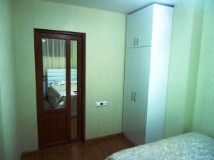 a bedroom with a mirror and a cabinet and a bed at Apartment on Getapnya 74 in Dilijan