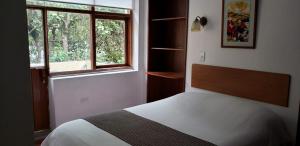 Letto o letti in una camera di Hostal Posada del Maple