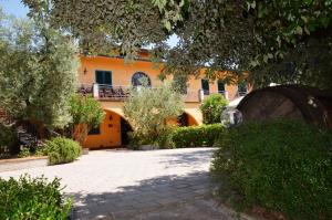 an orange building with a courtyard in front of it at Poggio Degli Olivi in Monsummano Terme