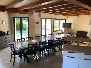 a kitchen and dining room with a table and chairs at LUCHON Chalet 16 Couchage in Montauban-de-Luchon